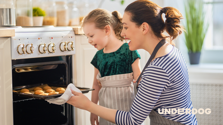 Une mère et sa fille mettent un plat au four