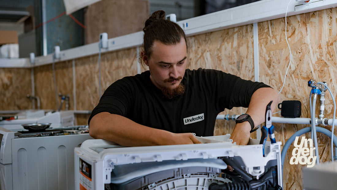 Un technicien répare un sèche-linge